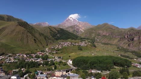 aerial boom shot above stepantsminda, georgia