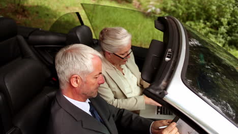 couple in a silver car