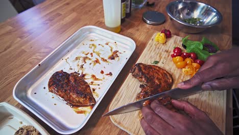 caribbean chef slicing jerked chicken