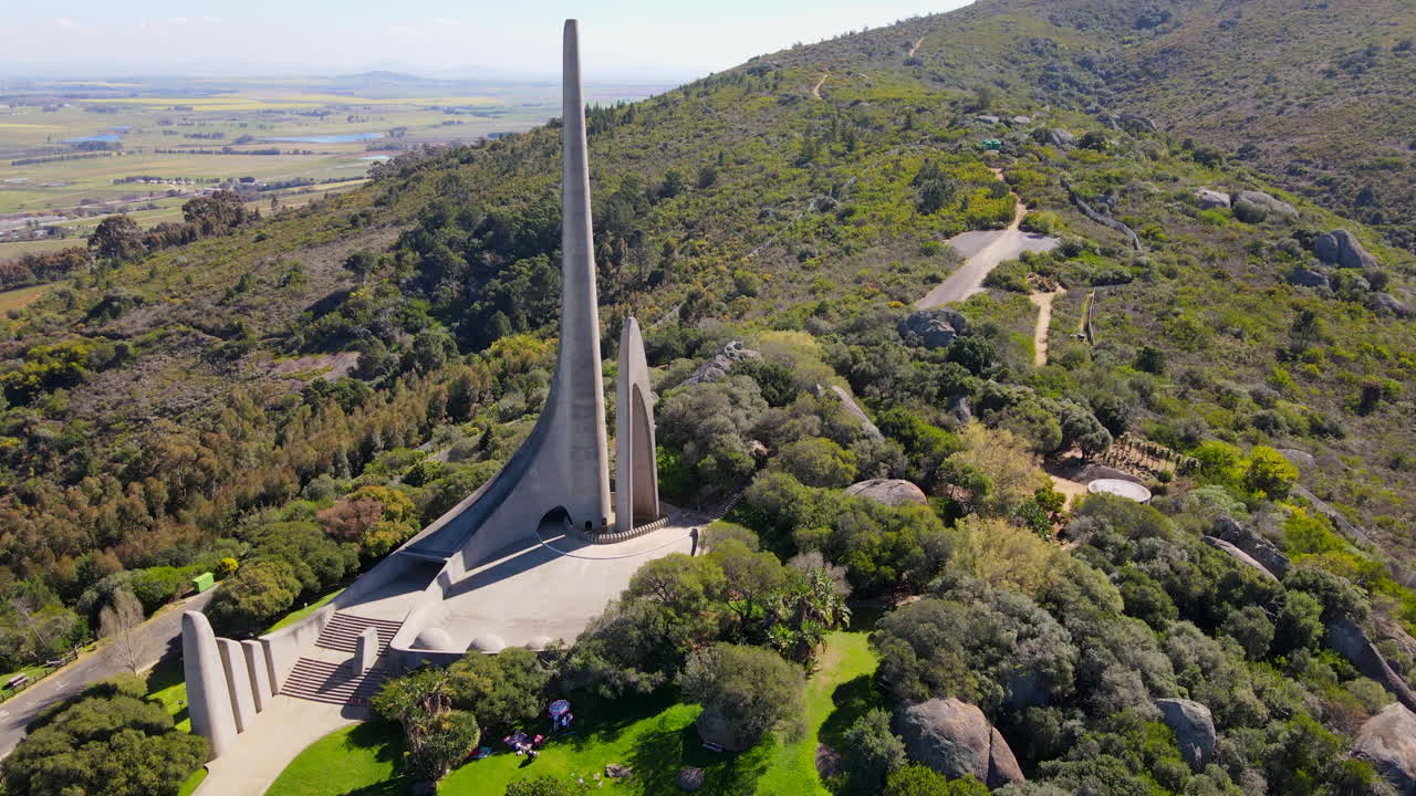 Drone tilt-up reveal shot of Afrikaans language monument on Paarl mountain