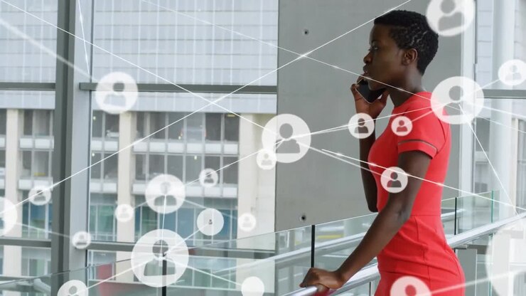 Network of profile icons against african american businesswoman talking on smartphone at office