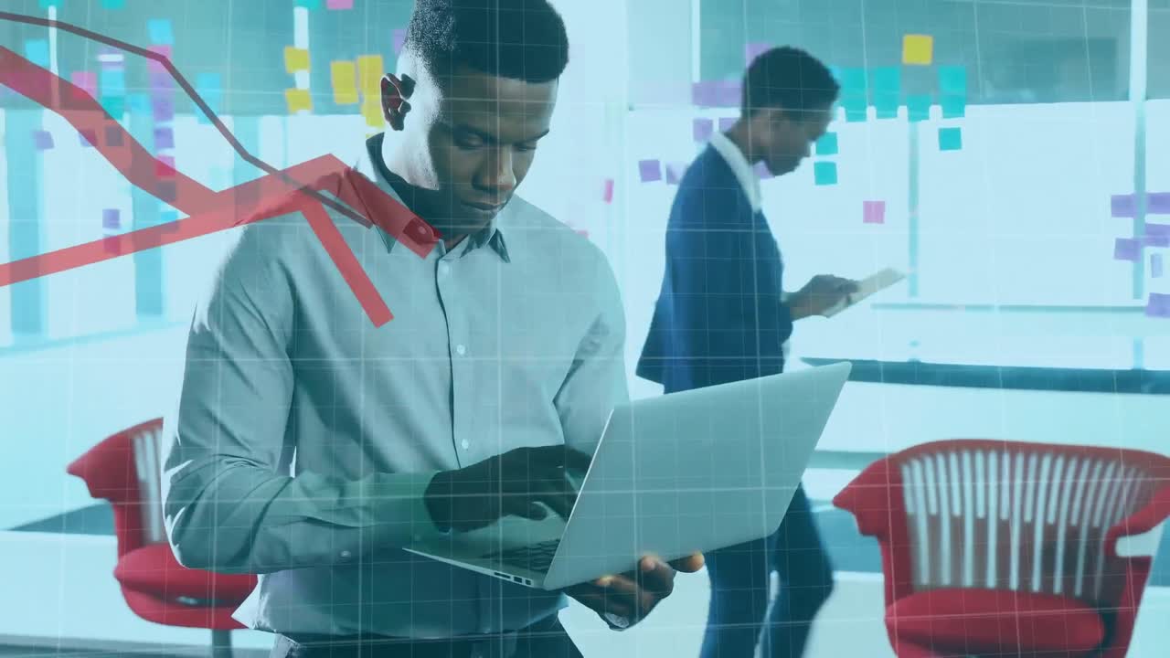 Animation of financial data processing with red lines over african american businessman using laptop