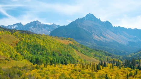 Timelapse,-San-Juan-Mountains-on-Sunny-Autumn-Day,-Forest-in-Yellow-Green-Foliage-and-Peaks,-Colorado-USA