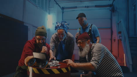 friends socializing and playing a game in a garage