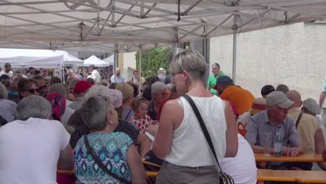 marble and apricot festival - visitors and stands on the main street, laas - lasa, south tyrol, italy