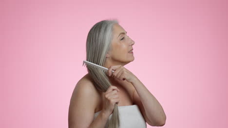 mature woman combing her hair