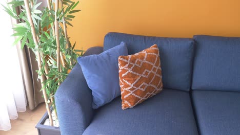 modern blue  sofa with pillows in living room at home