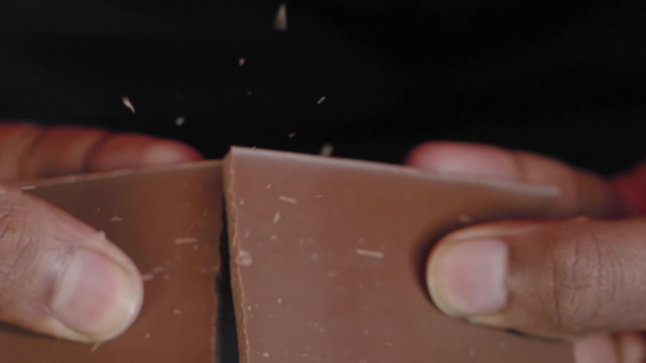 Hands holding a chocolate bar