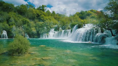 natural majestic waterfall at krka national park in croatia with its exceptional lush green natural beauty in spring time. cinemagraph / seamless video loop of the famous tourist vacation and filming location of the writer karl may western winnetou movies