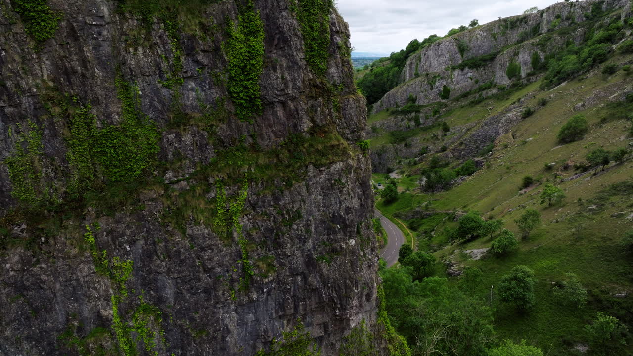 Steep Limestone Cliffs Of Cheddar Gorge In Somerset, England. Aerial Sideways Shot