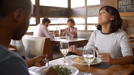 over shoulder view of couple having lunch in a restaurant