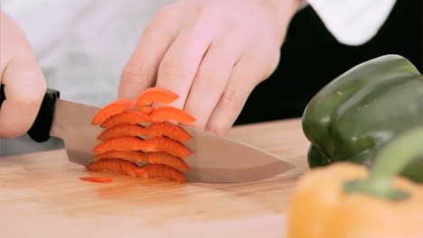 woman cutting a bell pepper in slow motion