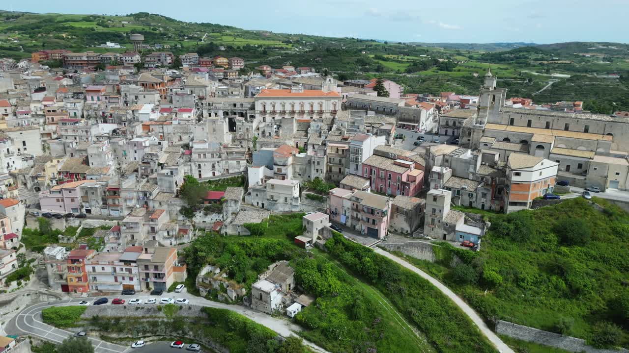 Aerial drone footage of Monterosso Almo, Sicily: ancient hilltop village with stone houses, narrow streets, and surrounding green valleys. Perfect for travel, culture, and documentary projects