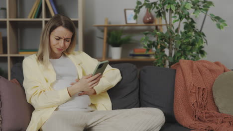 pregnant woman looking at phone