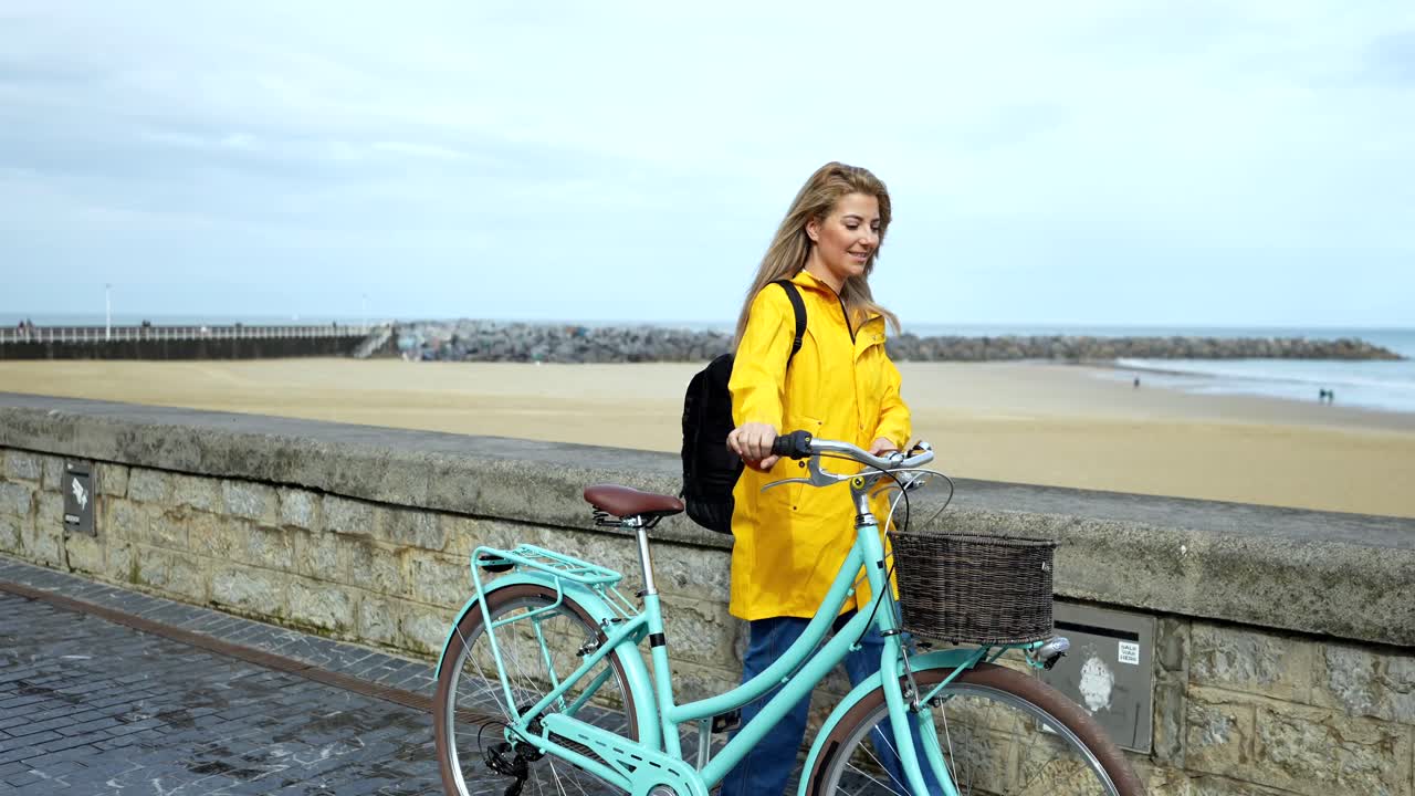 Woman with bicycle on the beach