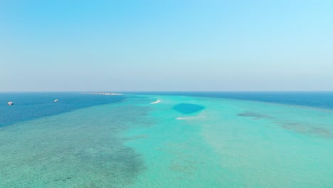 an awe-inspiring aerial drone view captures the rasdhoo sandbanks glowing under the soft, golden light of sunset in the maldives.