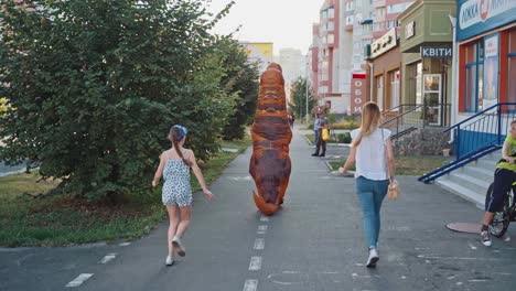 dinosaur walks on street. dinosaur doll tyrannosaurus rex walking on street city