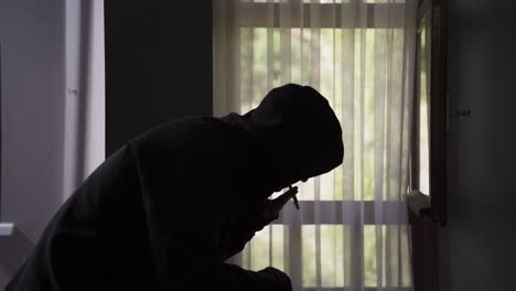 a young man lights a bite of marijuana and smokes it.