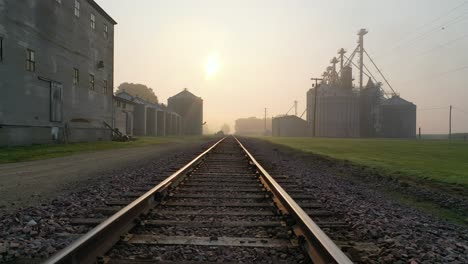 sunrise over rural railroad tracks