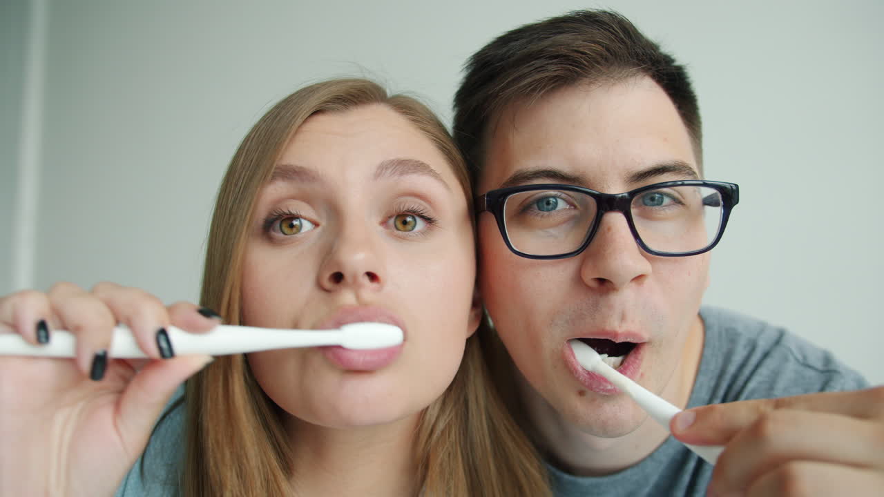 Couple Brushing Teeth Together