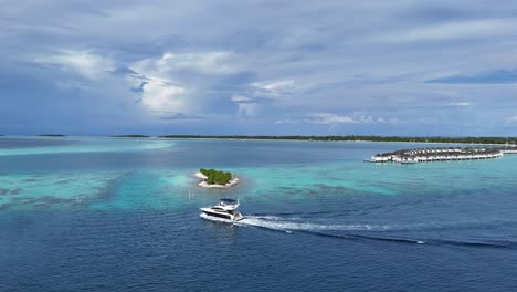 drone shot of speeding boat in the ocean during cloudy day