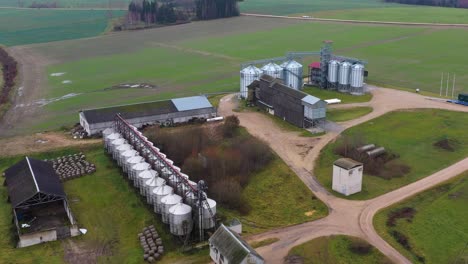 massive farmstead with modern shining silos, aerial view