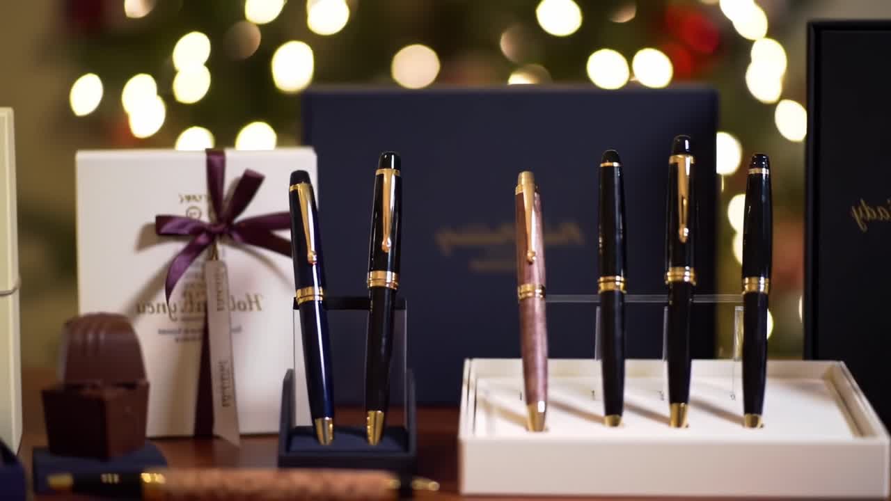 Showcasing Elegant Writing Instruments Amidst Festive Decor: A Collection of Luxurious Pens and Chocolates Highlighting the Perfect Gift Presentation
