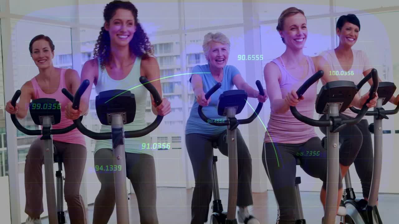 Five women cycling on spin bikes in studio, consoles driving updating metric overlays for fitness