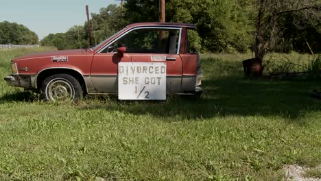 a car is cut in half with the sign divorced she got 1/2"" on it"" 1