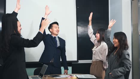 business people join putting hands as team during their meeting