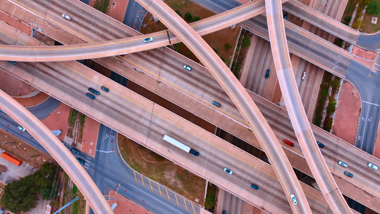 Lively traffic on the complicated road system. Top view. Highways and trestles with quickly moving cars