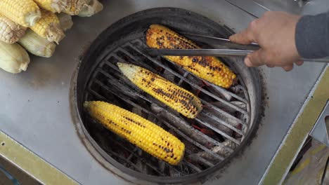 grilled corn on a street food cart