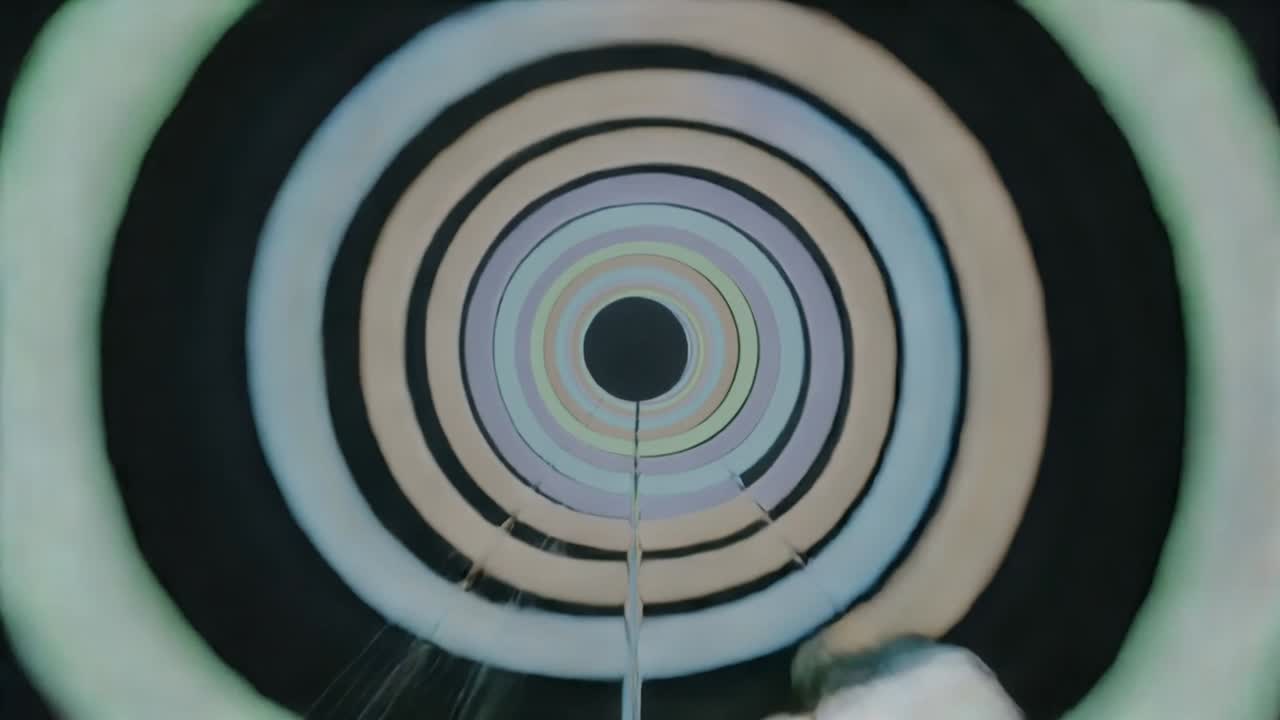 Color shift starting, concentric rings pulsing around core, showing rod, struts and metal object