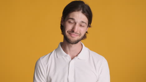 caucasian man in front of camera on yellow background.