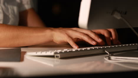 businesswoman using computer at night