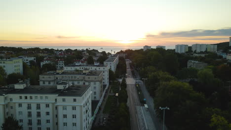 marvelous drone ascends from and empty polish street in gdynia to reveal miraculous orange sunset, aerial