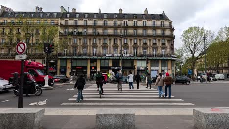 people crossing a busy street in paris