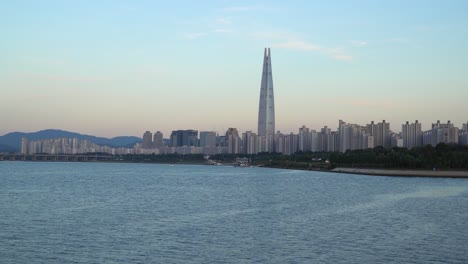 jamsil bridge and lotte tower on sunset , seoul south korea , han river waterfront