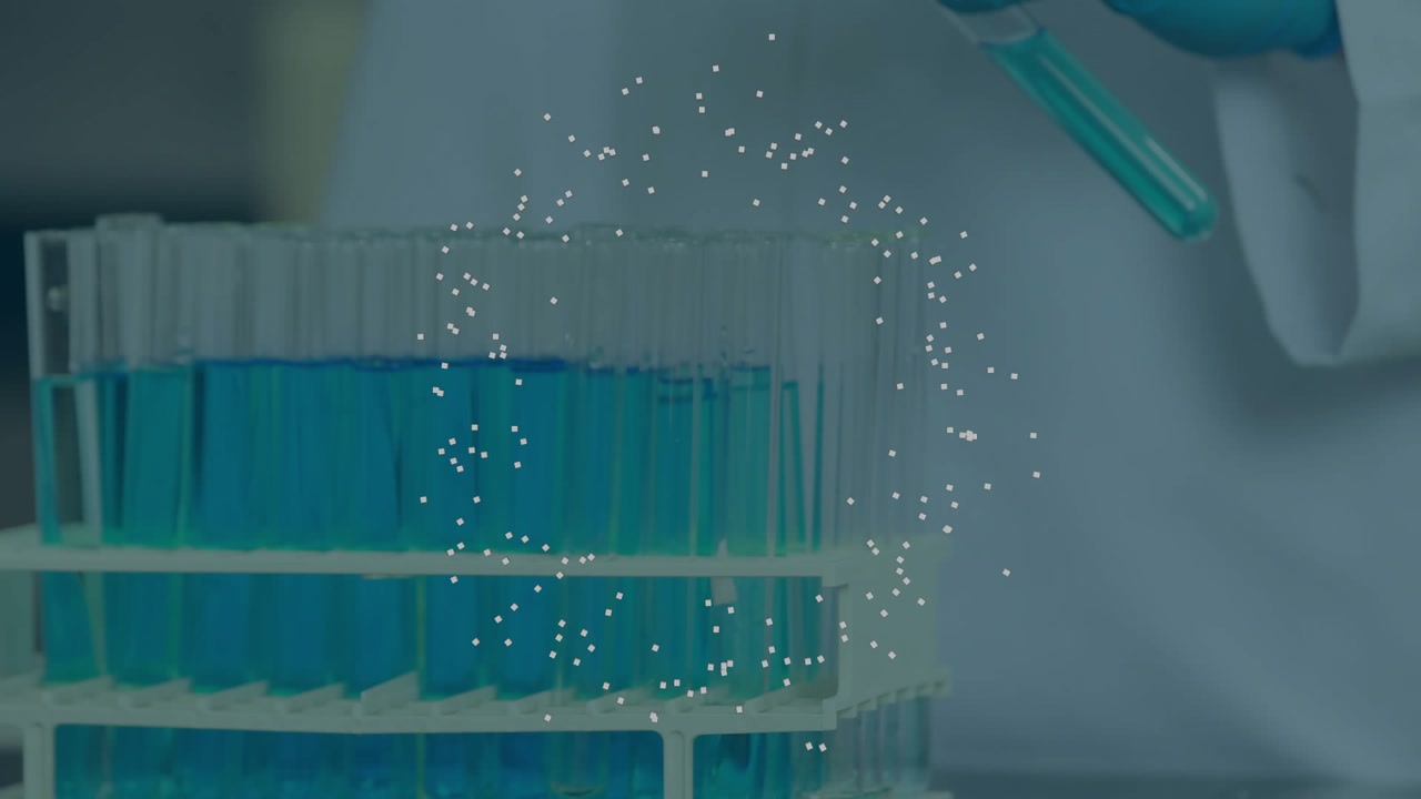 Gloved hand lifting, rotating test tube from lab rack to visualize particle swirl in blue solution