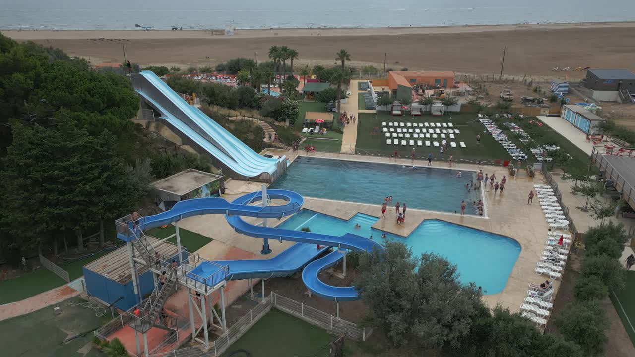 Aerial shot capturing visitors enjoying at AquaJet waterpark in Narbonne, France. Drone view.