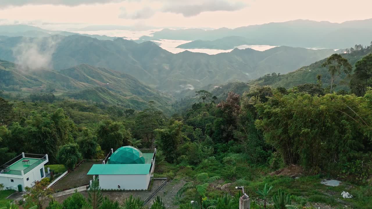 Luxury infinity pool with a person enjoying breathtaking mountain and cloud views, perfect for travel, lifestyle, wellness, resort, and tourism projects