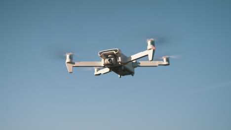 white drone flying on nature background