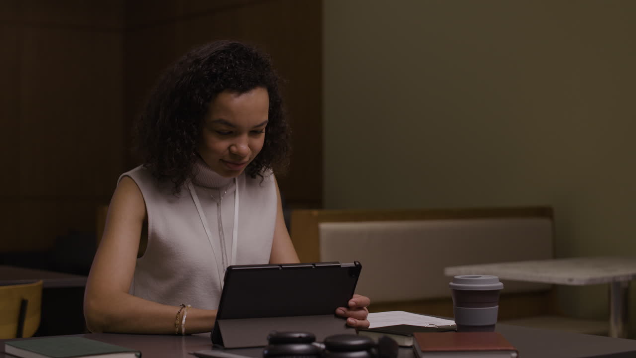 Woman working at desk with tablet