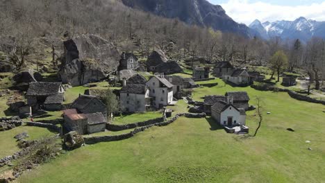 ancient village showcasing charming stone houses nestled amidst a picturesque natural landscape in the swiss alps, sabbione. ticino, switzerland, drone orbiting shot