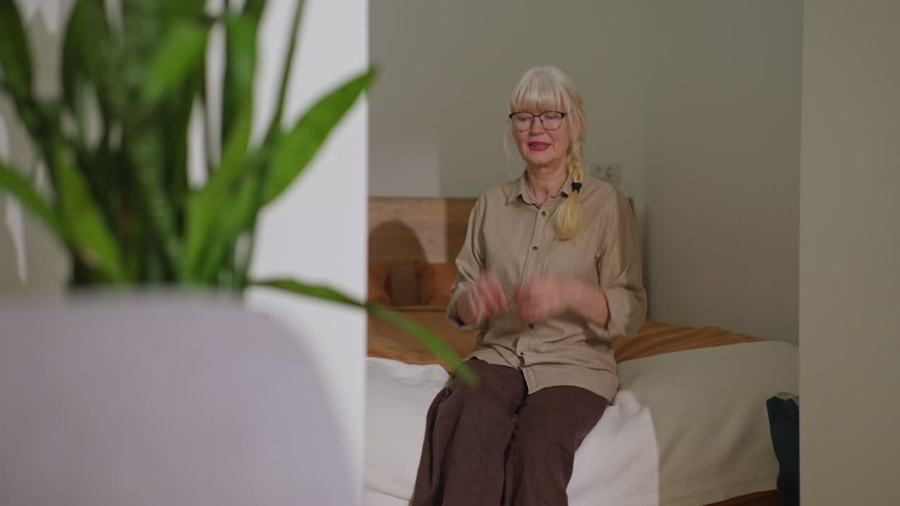 Senior woman experiencing chest pain in her bedroom