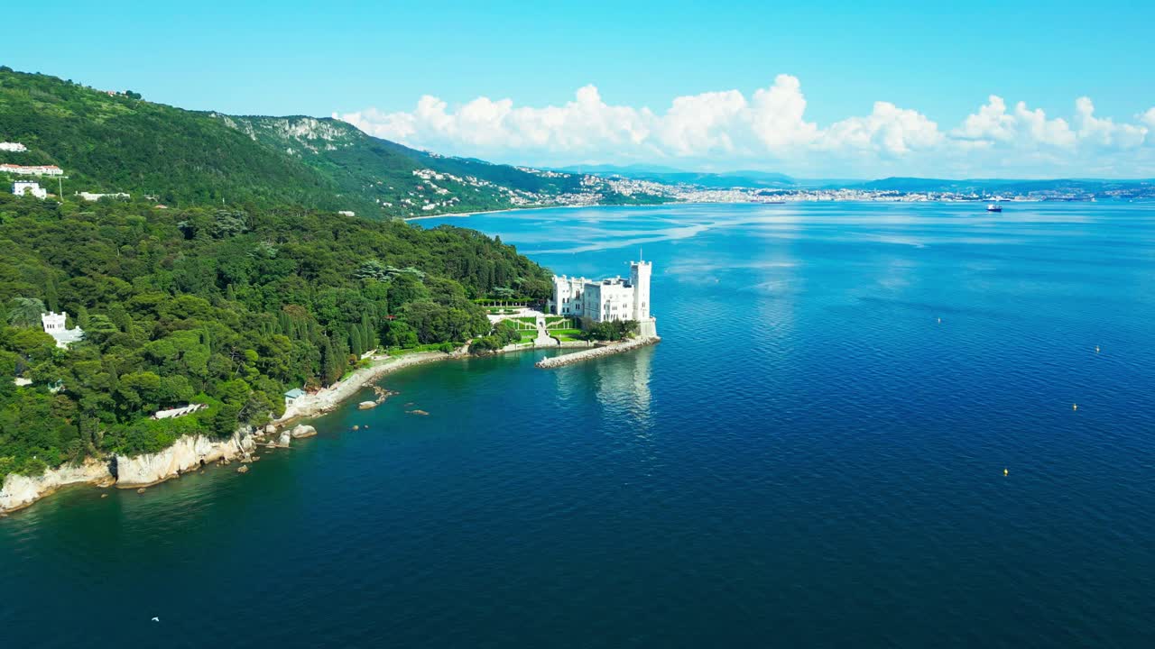 Overlooking the Gulf of Trieste, Miramare Castle rises from the rocky coastline, framed by emerald forest and endless blue sea—an iconic vision of elegance on Italy’s northeastern shores.