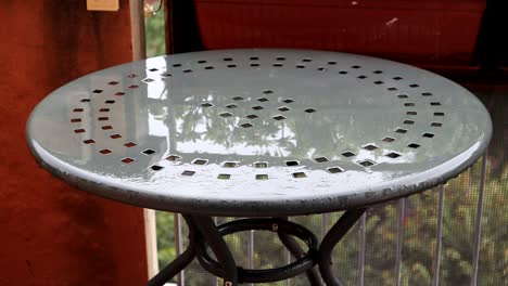 a metallic garden table under the rain in bologna