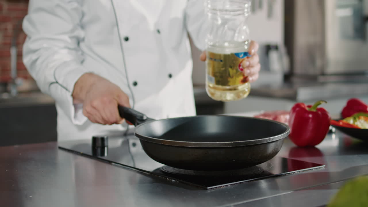 Authentic cook adding organic olive oil in frying pan