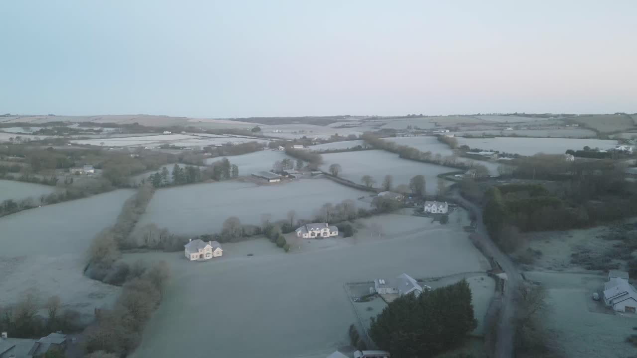 Frosty winter morning and aerial over hills and farmhouses in Ireland