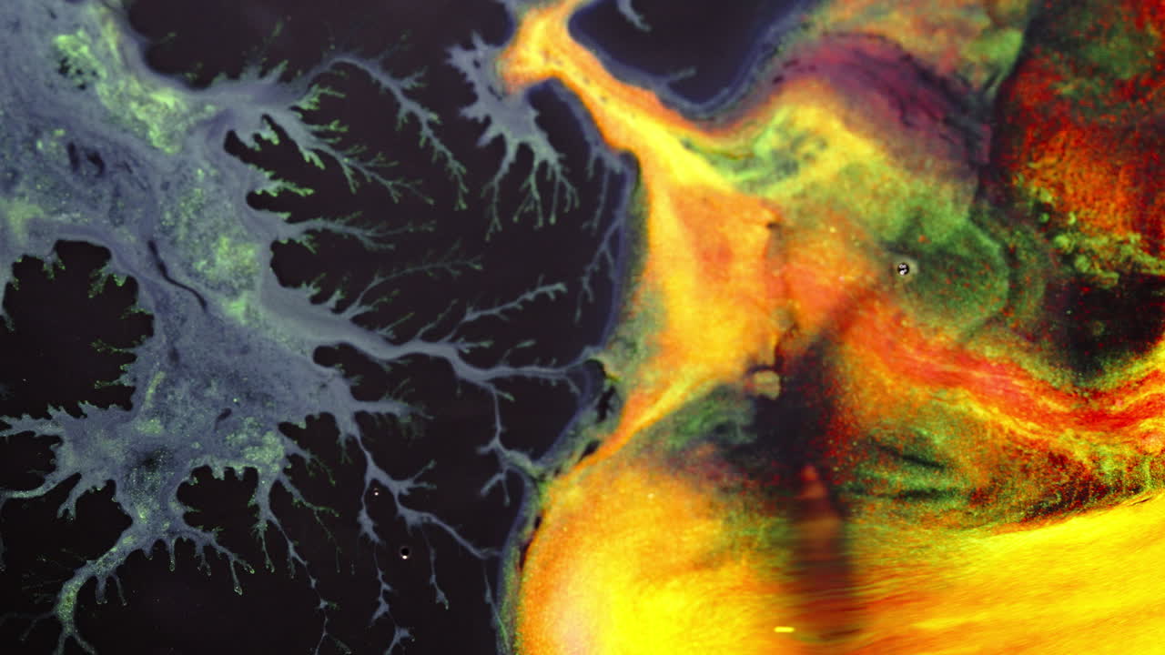 Substances mixing, macro shot of colorful fluid dynamics in motion, forming intricate patterns